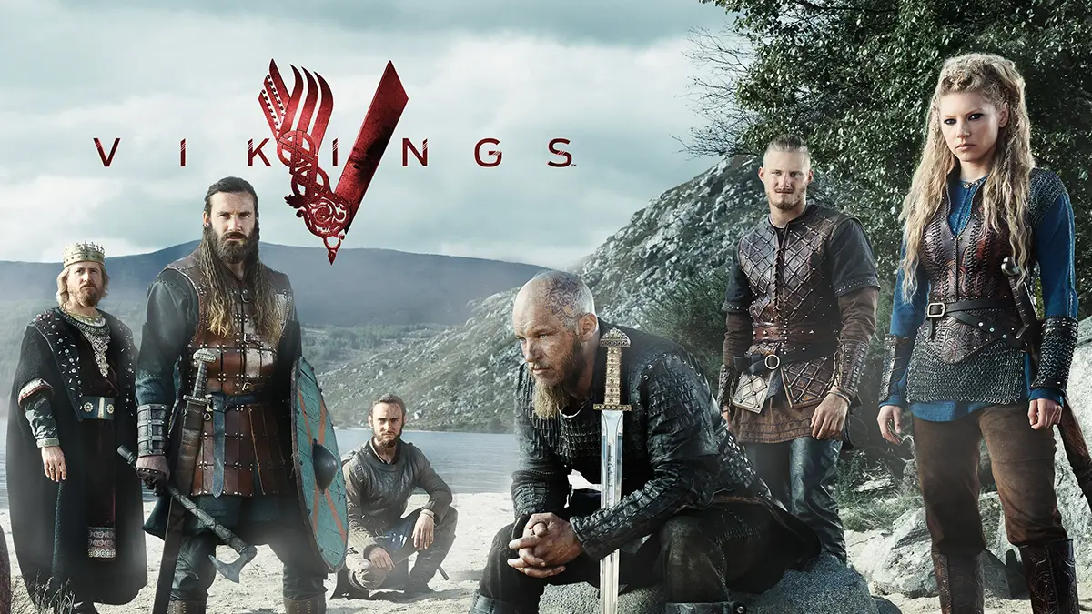 Affiche de la série Vikings montrant les acteurs dans leur tenue de Vikings au bord d'un lac